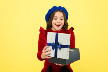 Shopping happiness. surprised small girl with present box. small girl hold holiday gift. happy birthday. boxing day. parisian girl in french beret go shopping. autumn fashion. school fall season