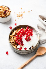 Yogurt with granola and berries in bowl. Healthy breakfast cereals with greek yogurt. Clean eating, dieting concept