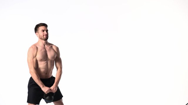 bearded Young man of athletic build is engaged in fitness on a white background. fitness trainer lifts weights