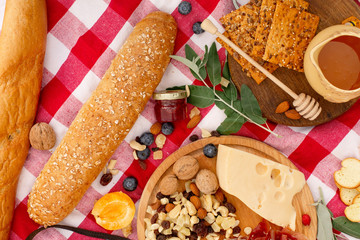 Stylish picnic on the green lawn. Fresh croissants and a teapot with tea on a bedspread near a wicker female hat. Instagram content