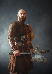 Angry viking with axe, martial spirit, barbarian - obrazy, fototapety, plakaty