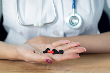 Doctor showing in hands activated charcoal.