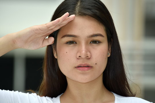 A Young Minority Female Saluting