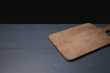 chopping board against a dark background
