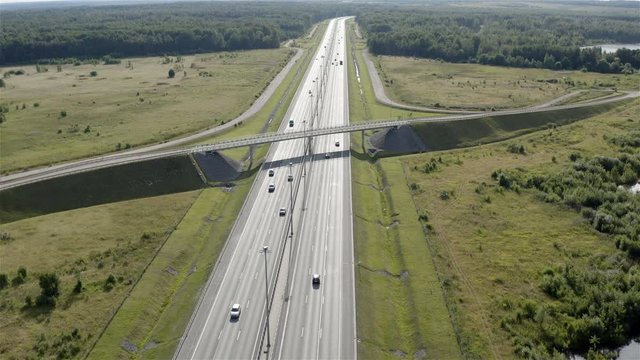 freight and passenger vehicles moving along the highway. Aerial photography.