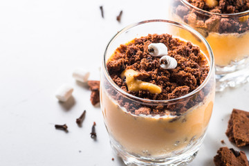 Halloween sweet dessert from cream pumpkin and chocolate.