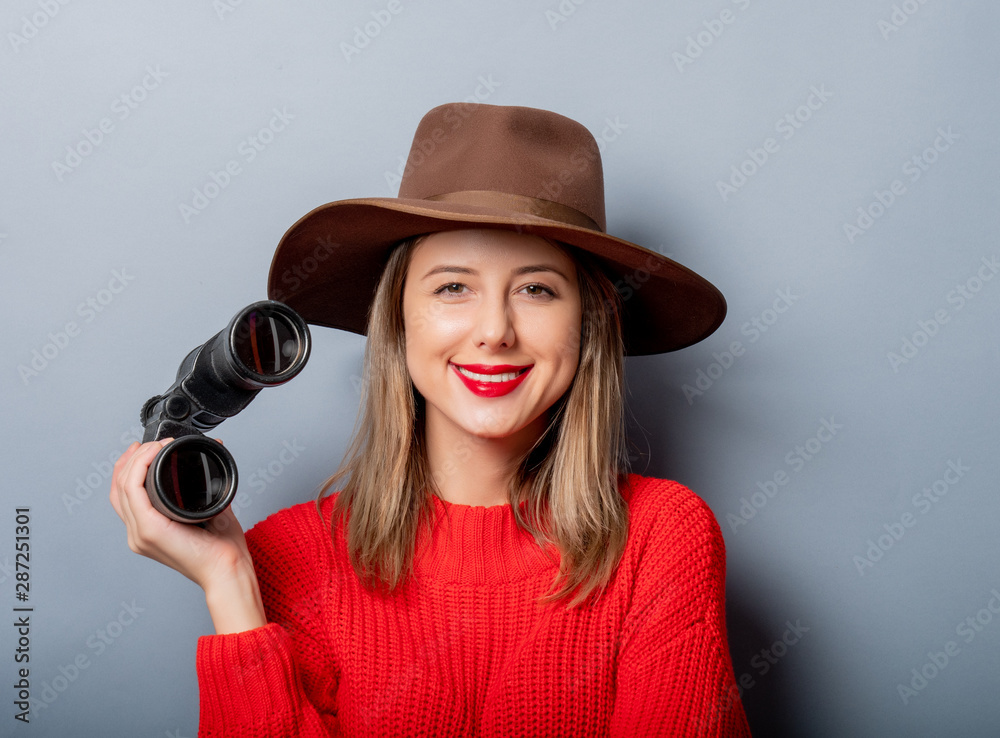 Sticker woman in red sweater and hat with binocular