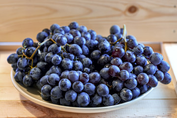 Red globe realistic grape bunch on a plate