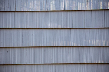 Wooden tiles or shingles typical of the northwestern pacific coast, painted white. wooden texture and geometrical patterns