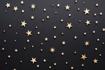 Christmas composition. Handmade wooden stars on black background . Christmas eve, dark night, Christmas decorations concept. Flat lay, top view, copy space - Powered by Adobe