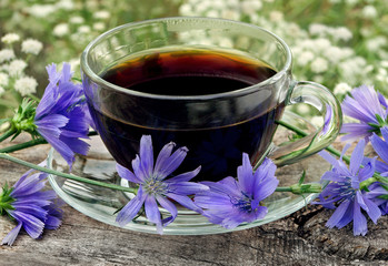 healing drinks. chicory drink. cup of chicory drink and flowers on a wooden table