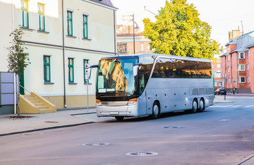 tourist bus is moving down the street