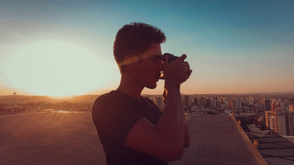 Photographer on top of the building at sunset