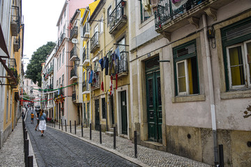 Fototapeta na wymiar Lisbon, Portugal - July 27, 2019: A typical narrow streets in the Old Town of Alfama, Lisbon