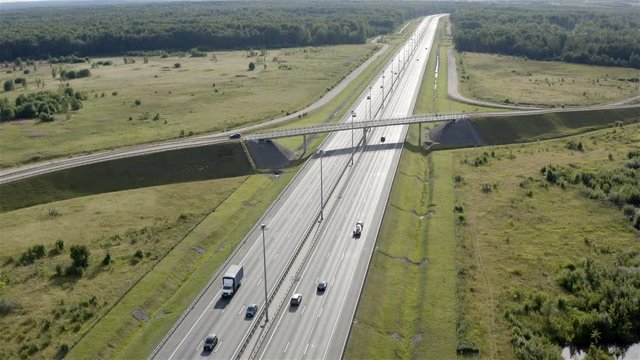 transport moves on a highway under a bridge.