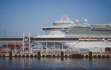 Fototapeta na wymiar Huge white cruise ship moored in the port.