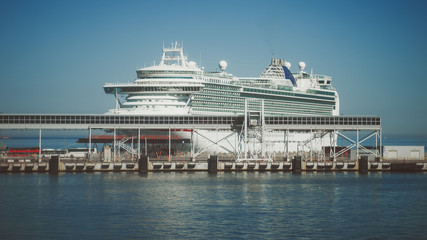 Naklejka premium Huge white cruise ship moored in the port.