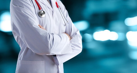 Doctor man in a white coat with a stethoscope on an abstract background