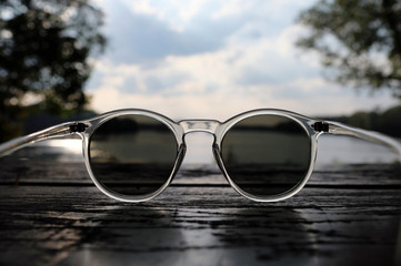 Fototapeta na wymiar Gorgeous sky over a lake seen above a pair of sunglasses