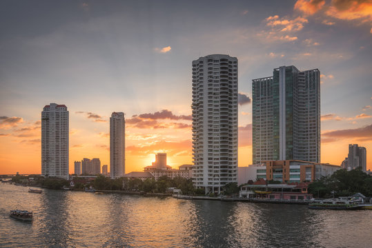 Sunset in the City of Bangkok, Thailand. Chao Phraya River Embankment with Skyscreapers.