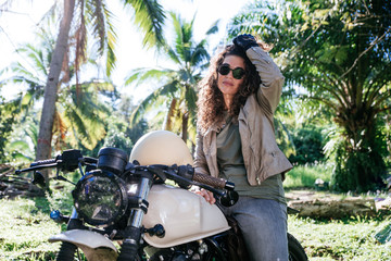 Fototapeta premium beautiful woman making a jungle tour with her motorcycle