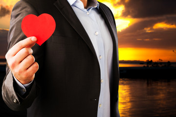 Businessman in a classic suit with an red heart on background