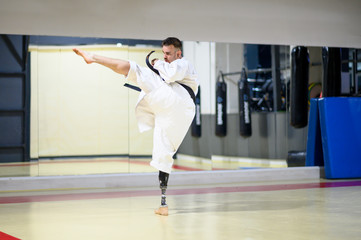Man with prosthetic leg practicing karate © OscarStock