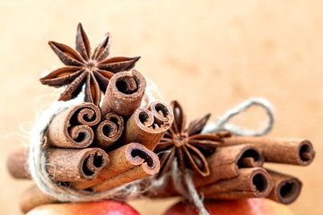Red apple with cinnamon sticks spices decorated anise with star. Festive Merry Christmas composition. New year card. Holiday theme. Banner Background