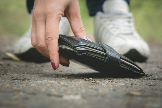 Woman is found a wallet on a road.