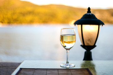 Wine glass table setting in a summer restaurant with sea view