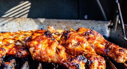 BBQ sauced Chicken legs and breasts on the grill. Calgary, Alberta, Canada