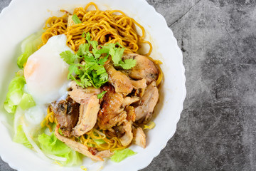 Egg noodles served dry with roasted honey chicken and soft-boiled eggs (onsen tamago eggs)