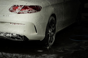 White car washing in carwash shop.