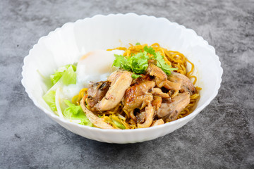 Egg noodles served dry with roasted honey chicken and soft-boiled eggs (onsen tamago eggs)