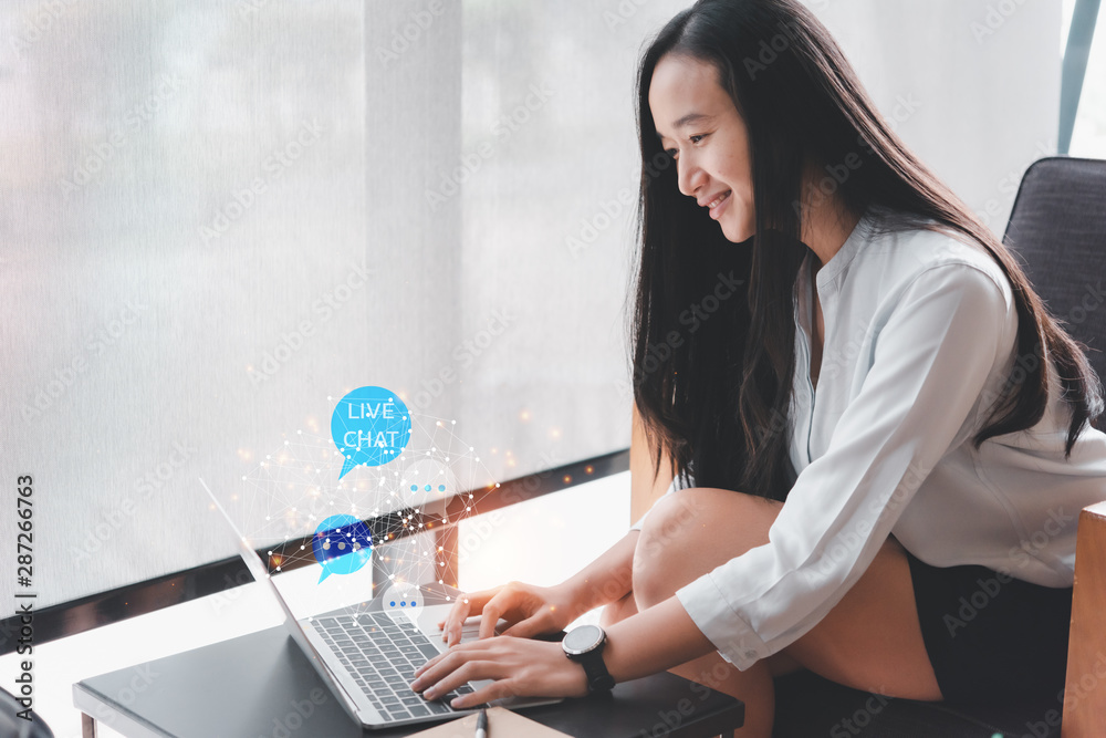 Poster live chat technology concept,beautiful asian woman using computer laptop in coffee shop and she's sm