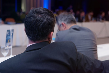 Businessman at business conference room with public giving presentations. Audience at the...