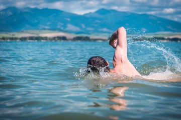 Men Swimming in a Lake