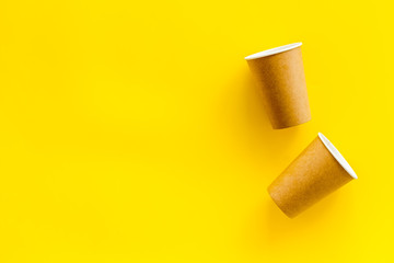 paper cups for coffee to take away on yellow background space for text