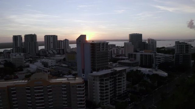 Aerial: High Rise Buildings Near Water With the Sun Setting - Darwin, Australia