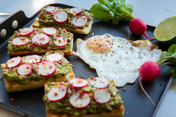 Avocado toast with radishes and fried egg