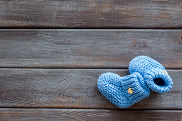 Booties for newborn boy on wooden background top view mock up