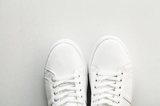 Stylish white fashion sneakers on white background.