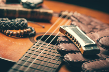 vintage harmonica on acoustic guitar - obrazy, fototapety, plakaty