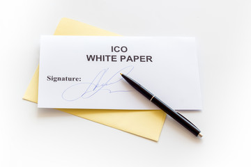 Initial coin offering ICO white paper, pen on white background