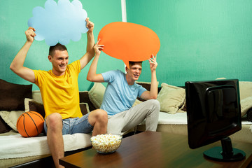 Beautiful young adult brothers, holding speech bubbles above head, basketball fans concept. Add text 