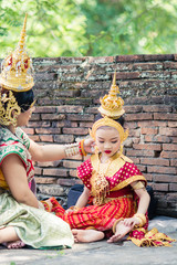 Asian woman wearing typical, traditional Thai Dress. It is literally means "Thai outfit", National costume.