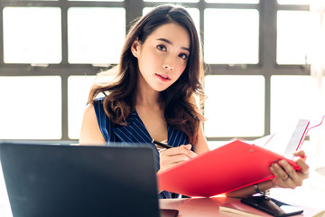 Businesswoman sitting working with laptop computer.creative business people planning in her...