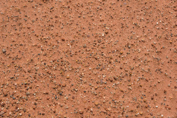 Orange hard earth with gravel background texture