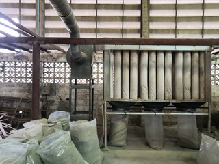 Wood dust filtration system from Wood Cutting Panel Saw Machine at the furniture factory.Dust...