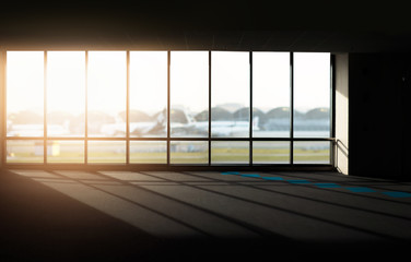 Naklejka na ściany i meble Windows with sunset at Airport.